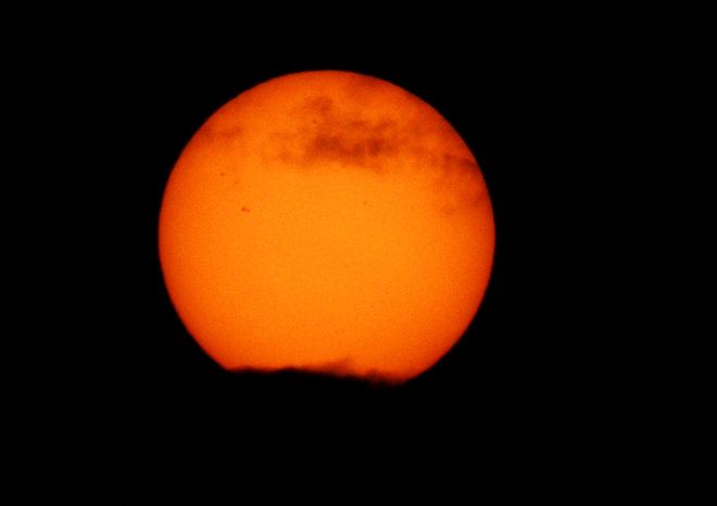 Sun with Clouds and Sunspots